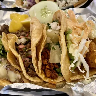 Left to right: birria, steak chimichurri, Al pastor, fish.