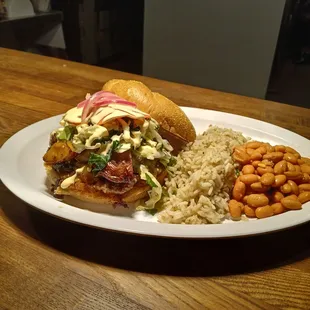 Santa Fe burger: a brunch banger . Smashed patty, sharp cheddar, green chile, crema, pickled vegetables and o/e egg on a grilled bun