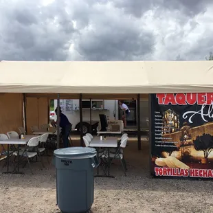 tables and chairs under a tent