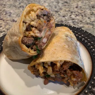 Half a carne asada burrito (a bit dry), half an al pastor burrito (YUM)