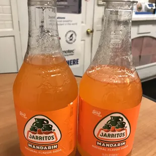 two bottles of jarrito mandarin orange juice