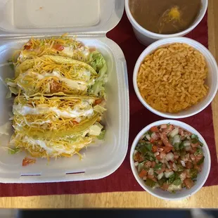 Hard shell tacos with large rice, large beans and pico de gallo.