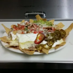 Deliciosos nachos con carne jalapeños  pico se gallo crema y guacamole ven a disfrutarlos en taqueria  ana maria&apos;s