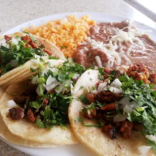 $5.59 special: 3 tacos, rice, beans, + medium drink. [Al pastor, asada, pollo, + horchata]