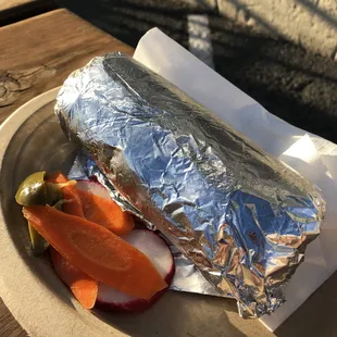 a burrito and vegetables