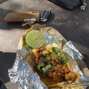a taco with a lime wedge