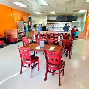 a dining area with tables and chairs