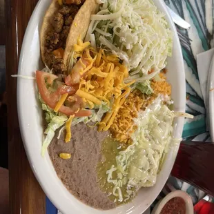 Tex Mex Dinner enchilada, taco, and tostada rice and beans with all means.
