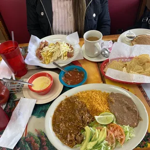 Carne guisada plate, queso, beacon egg and cheese breakfast taco, fries, pancakes, coffee and sprite.
