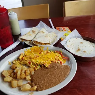 Chilaquiles with refried beans and potatoes and flour tortillas. Ordered three bean and cheese tacos also. 4/5