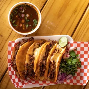 a plate of tacos and a bowl of salsa