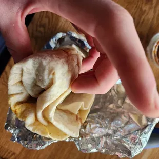 a hand holding a taqueria