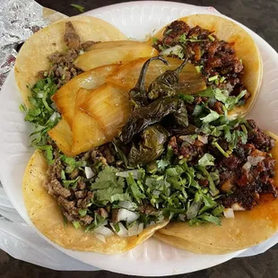 three tacos on a paper plate