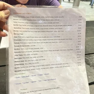 a man holding a menu