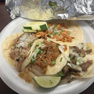 Four tacos: tinga (top), al pastor, and i forget