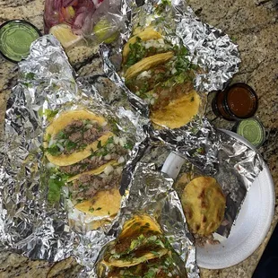 a variety of tacos on aluminum foil