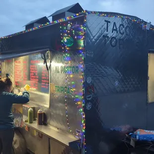 a woman preparing food from a food truck