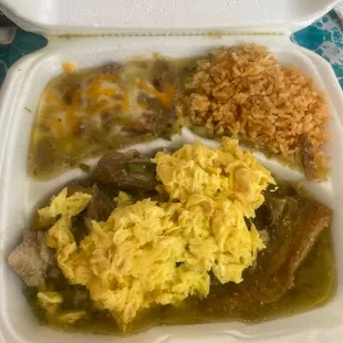 a white styrofoam container filled with rice, beans, and meat