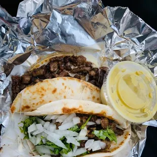 Fajita quesadilla and Fajita taco with onions, cilantro and salsa verde.