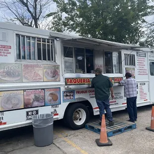 two men ordering food from a food truck