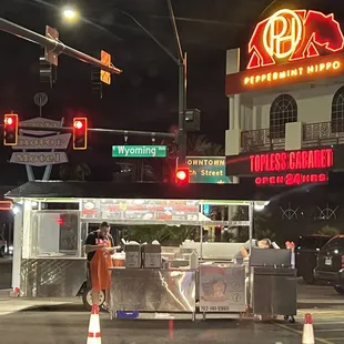 a man standing in front of a restaurant