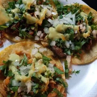 pastor, pollo, and fajita tacos with onion, cilantro, and salsa