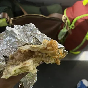 a person holding a piece of food