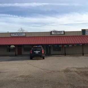 a car parked in front of a restaurant