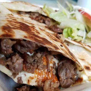Cross section of carne asada quesadilla with beans and rice