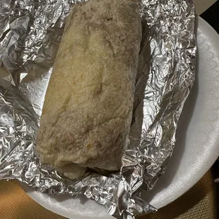 a burrito wrapped in aluminum foil