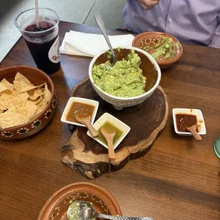 Guacamole and chips with three spice levels of salsa