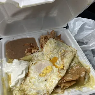 Chilaquiles verde with chicken and eggs.