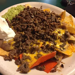 The asada nachos, grande size. Served with sour cream &amp; guacamole.