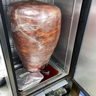Trompo puerco in cooler waiting to be turned into mouth watering Trompo Tacos!!!