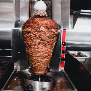 Al Pastor Cooked on the trompo the Authentic way with our signature Adobo recipe made from scratch in house.