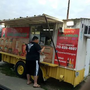 a man standing in front of a food truck