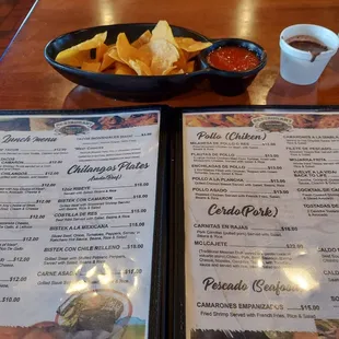 a menu and a bowl of chips