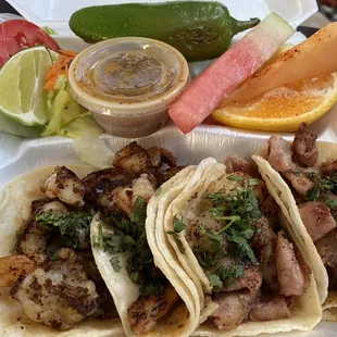 2 shrimp on left, 2 Tripas on right, with salad and fruit. Salsa is amazing!