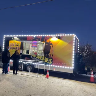 people standing in front of a food truck