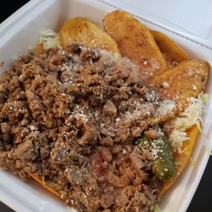a close up of a taqueria in a styrofoam container