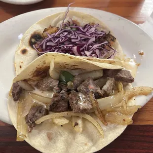 Blackened shrimp taco and Philly cheesesteak taco