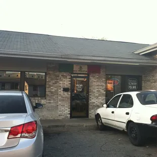 two cars parked in front of a restaurant