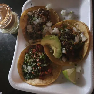 Pastor, Carnitas, &amp; Beef Fajita corn tacos. Comes with green &amp; red salsa.