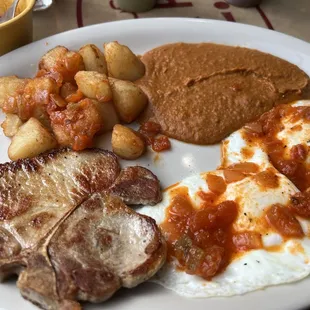 37. Chuleta de Puerco Pork Chop breakfast plate with sauce on the side so I could put it where I want. Delicious!