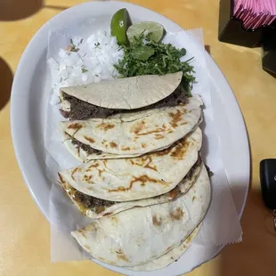 Barbacoa taco on corn (first one) , barbacoa on flour, asada a la Mexicana quesadilla, asada a la mexicana taco)