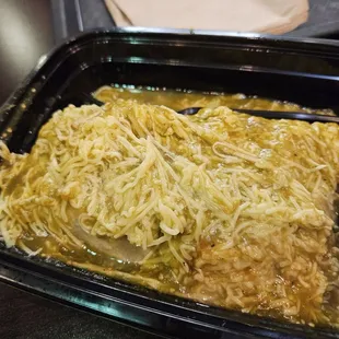 Carnitas burrito wet style with chili Verde sauce