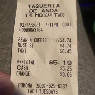 a hand holding a receipt