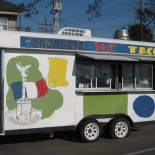 a taqueria truck parked on the side of the road