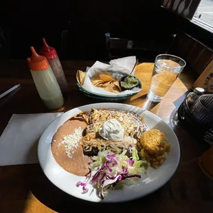 Three enchiladas de Mole . It&apos;s delicious during this cold  weather. The rice is made right, mole is a light sweet to it.