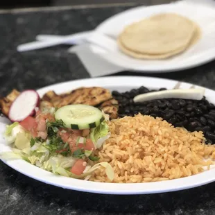 Chicken, rice and beans, and salad